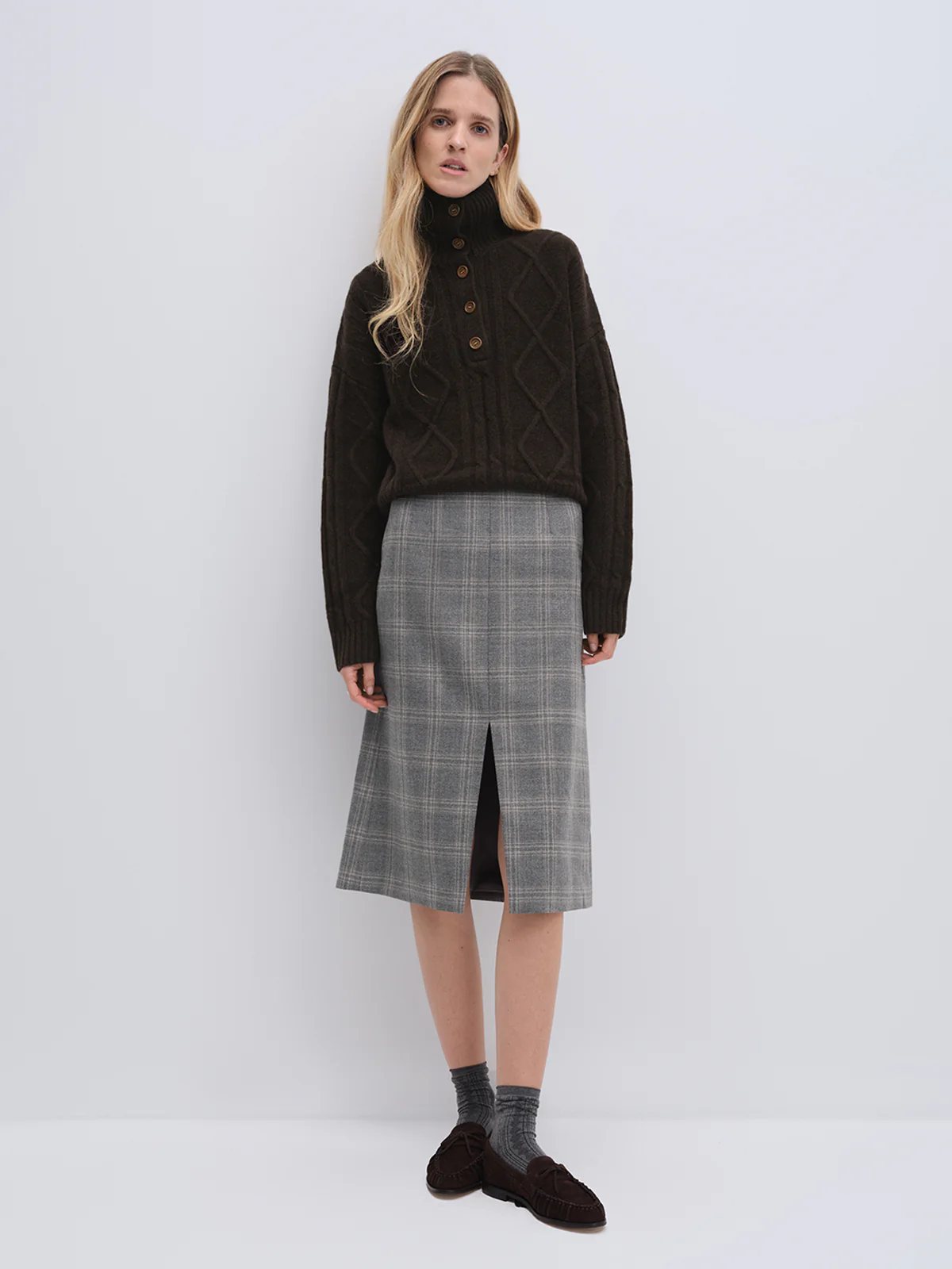 Model in andreatang blue-grey wool check midi skirt with dark brown cable sweater