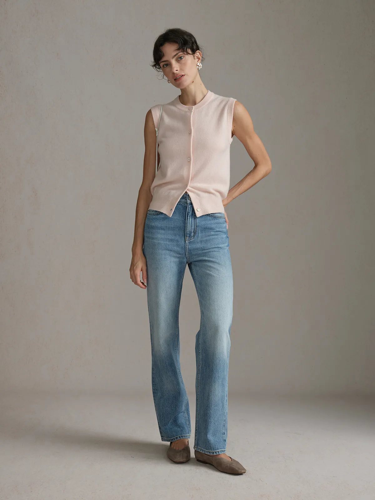 andreatang RANDY cashmere wool knit vest in blush worn with wide-leg jeans and flat shoes, full-body front view