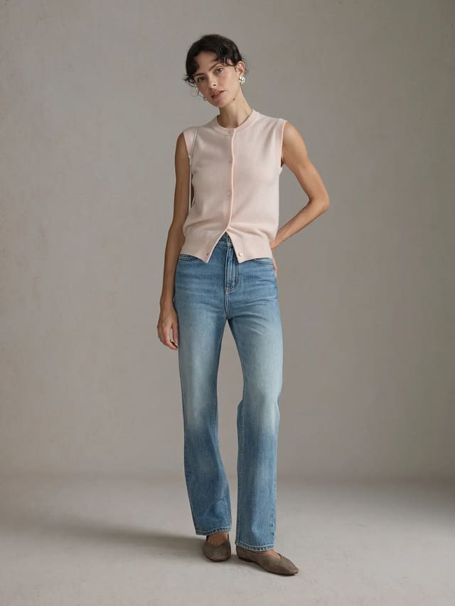 andreatang RANDY cashmere wool knit vest in blush worn with wide-leg jeans and flat shoes, full-body front view