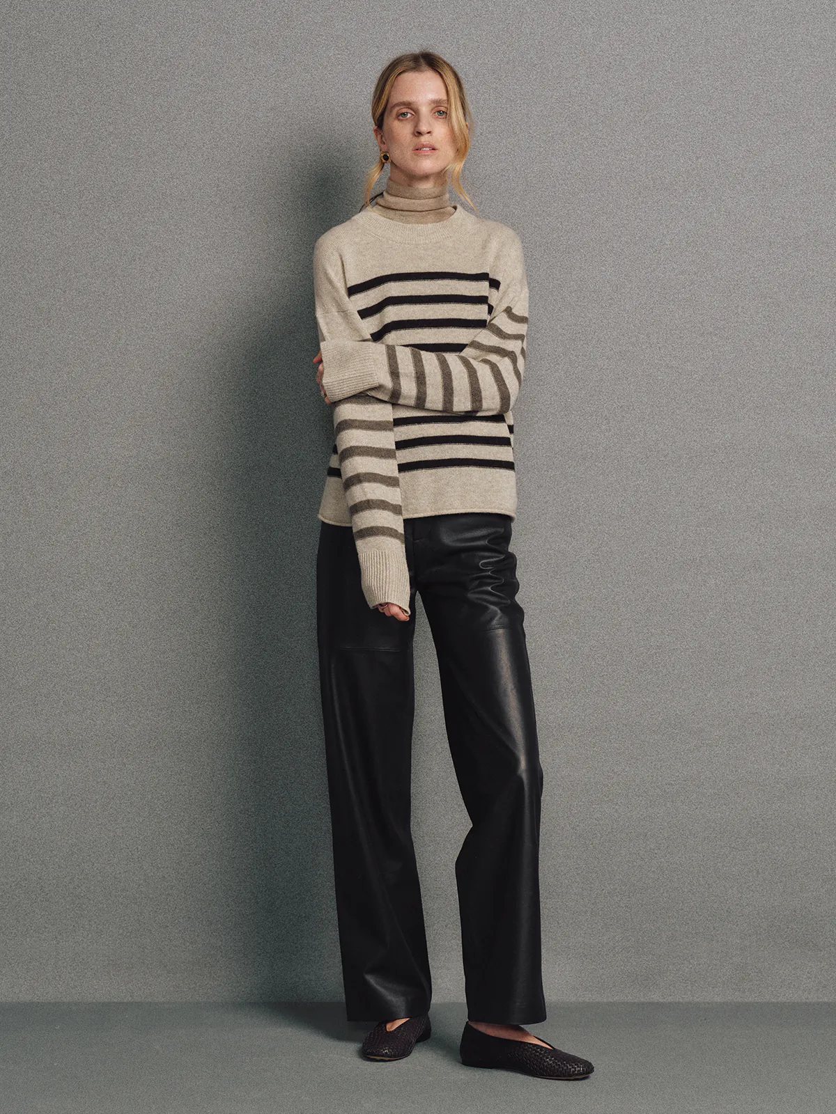 Model wearing a Light Brown contrast stripe cashmere wool jumper, front view with hands at sides.