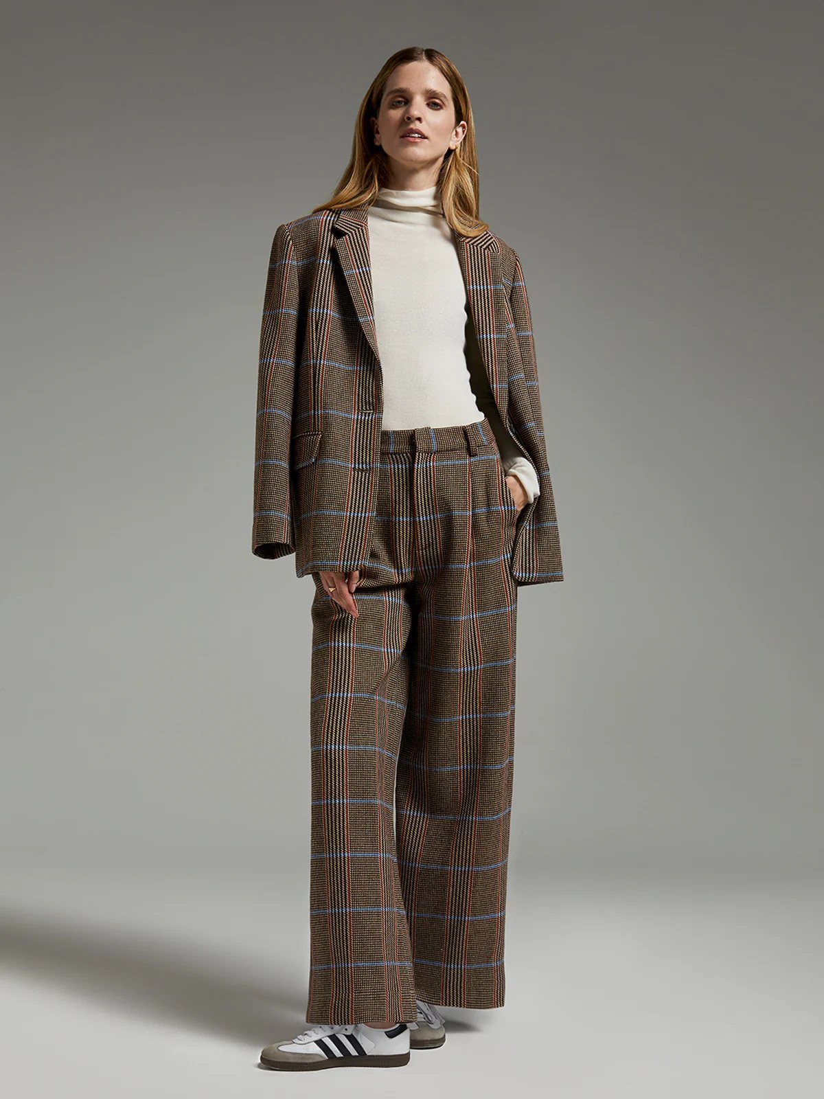 Model wearing andreatang pure-wool British check blazer with matching wide-leg trousers and ivory turtleneck