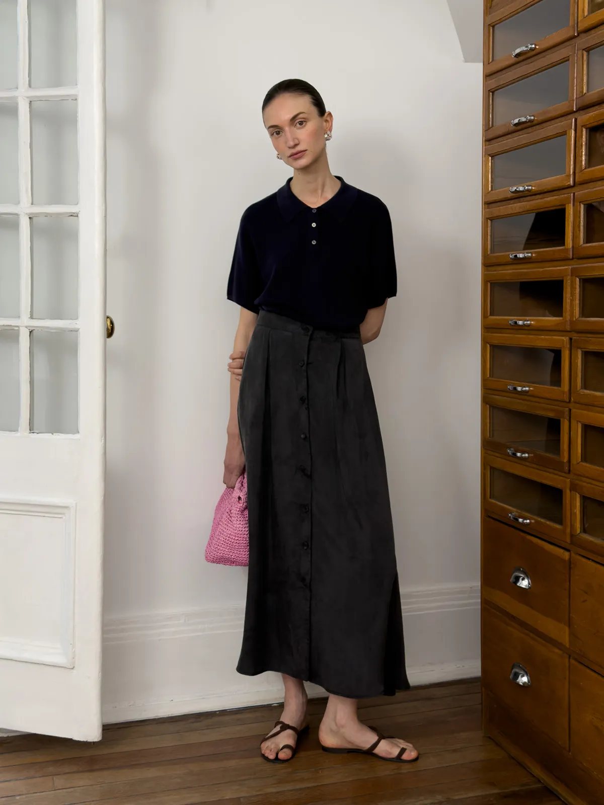 andreatang NADINE navy knit polo with black button-front midi skirt and pink crocheted bag