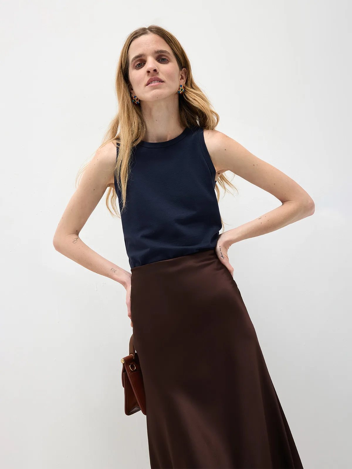 Model in navy HOLLY tank top with chocolate satin maxi skirt, hands on hips