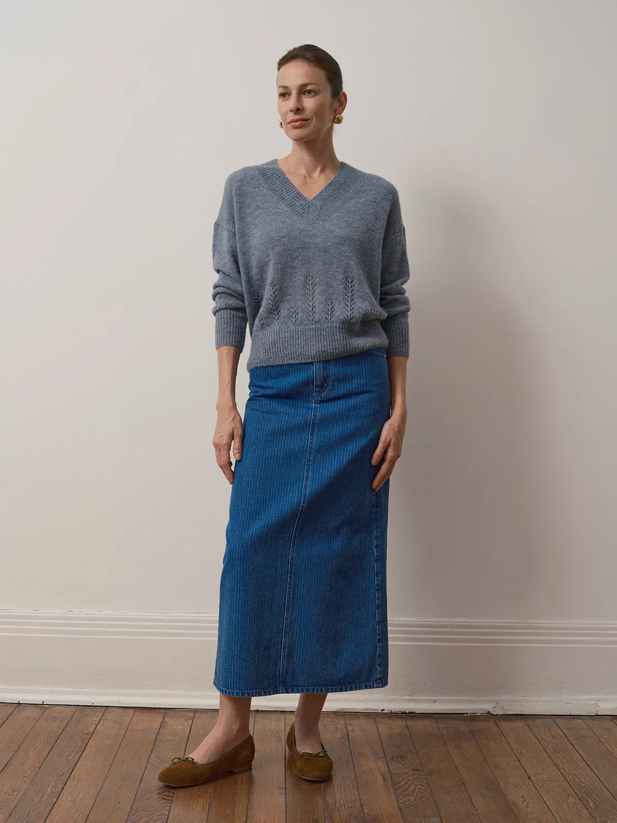 Front full-body shot of model in BRYCE striped denim maxi skirt with gray V-neck sweater and brown suede flats