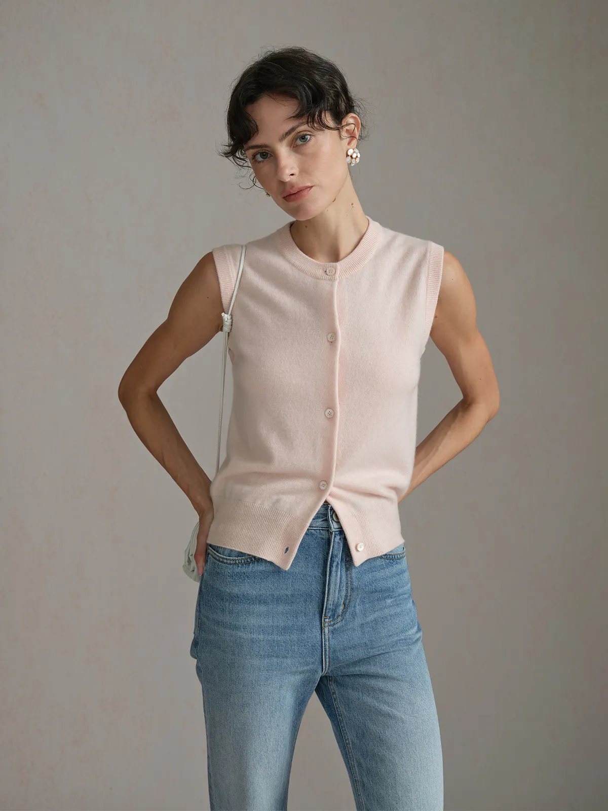 andreatang RANDY vest front view with model hands on hips, carrying small white shoulder bag