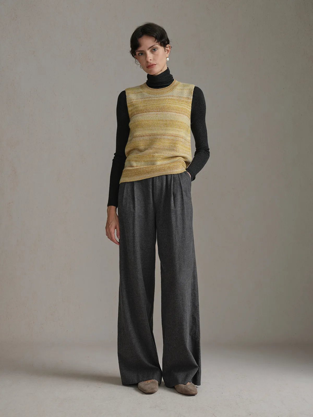 andreatang RIPPLE Gradient Stripe Knit Jumper layered over black turtleneck with grey wide-leg trousers, quiet luxury styling