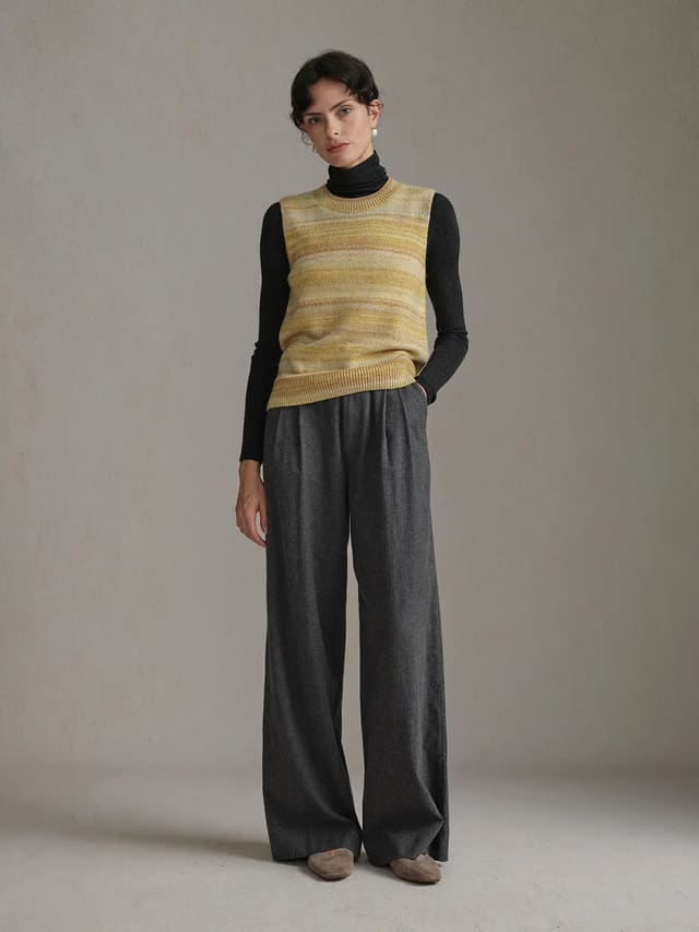 andreatang RIPPLE Gradient Stripe Knit Jumper layered over black turtleneck with grey wide-leg trousers, quiet luxury styling