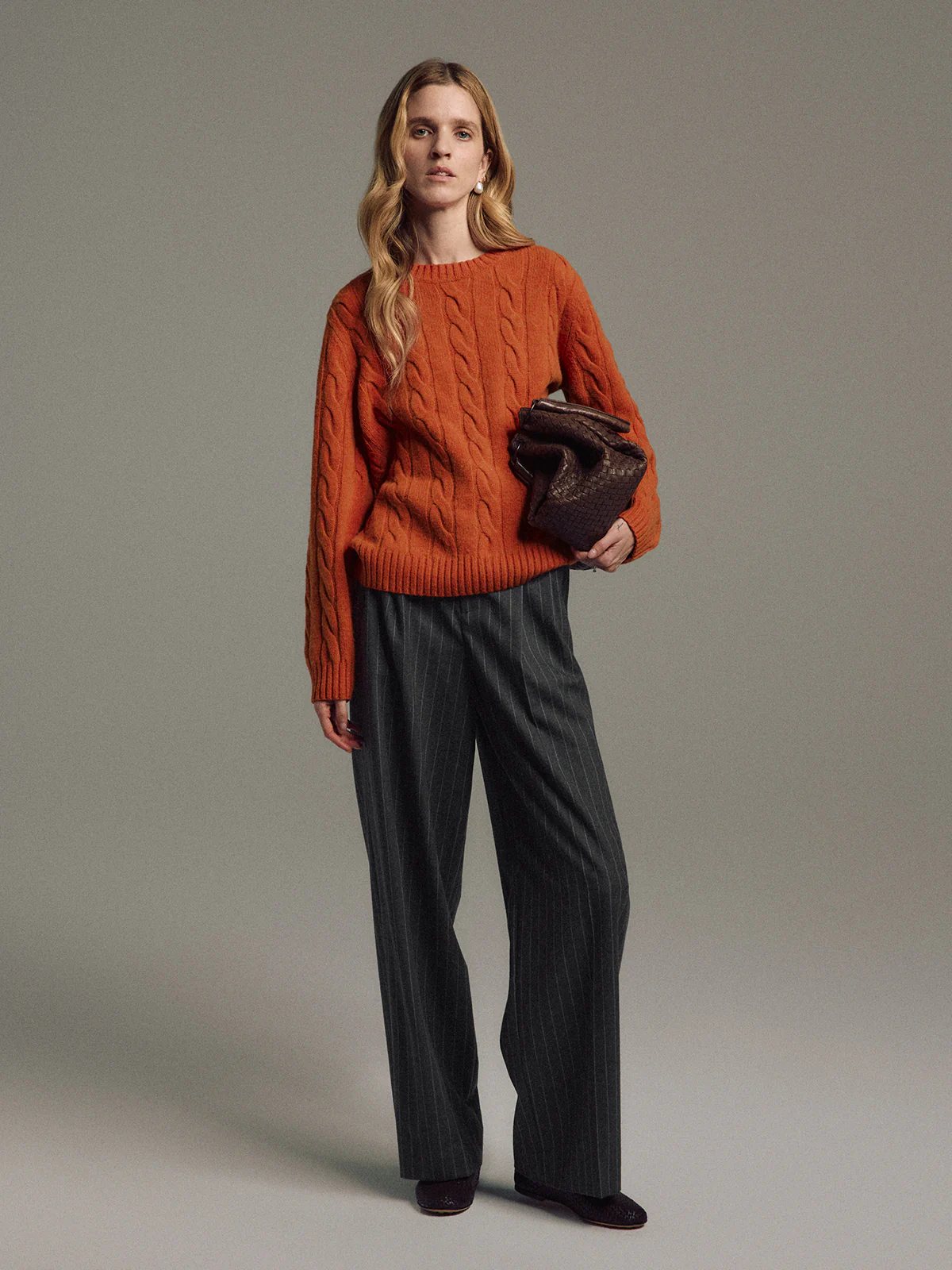 Front view of model in Dark Gray wool striped wide-leg trousers paired with light turtleneck.
