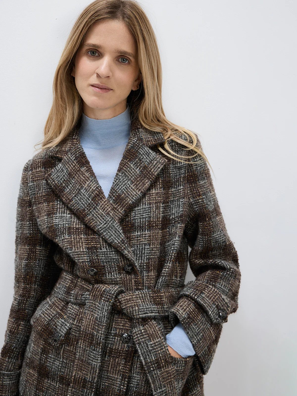 Close-up of the Dark Brown wool alpaca tweed check coat showing notched lapel, double-breasted button closure, and belted waist.