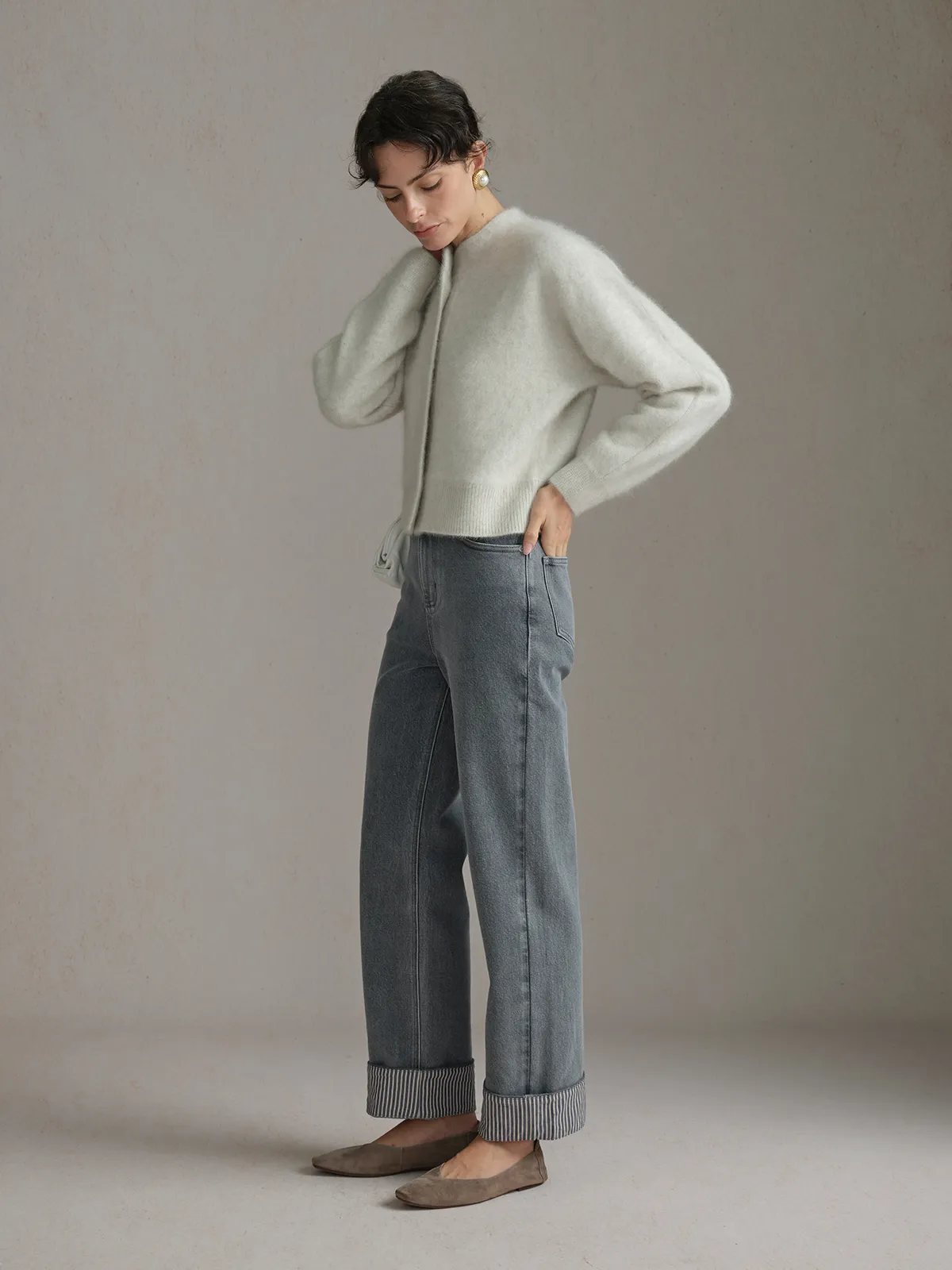 Model in mint green knit sweater and FLIPSIDE Stripe Cuffed Jeans, side profile on neutral background