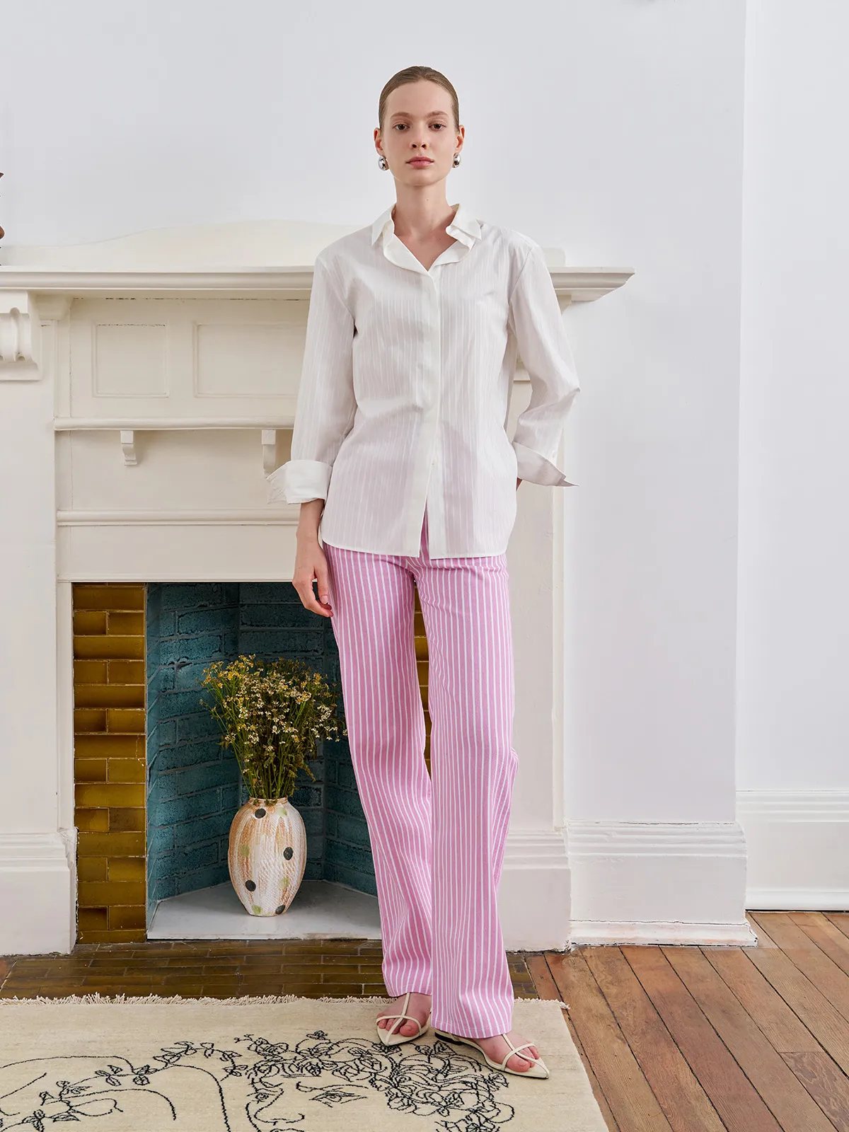 Full-length front view of model in PINKY pink stripe straight leg jeans and white shirt