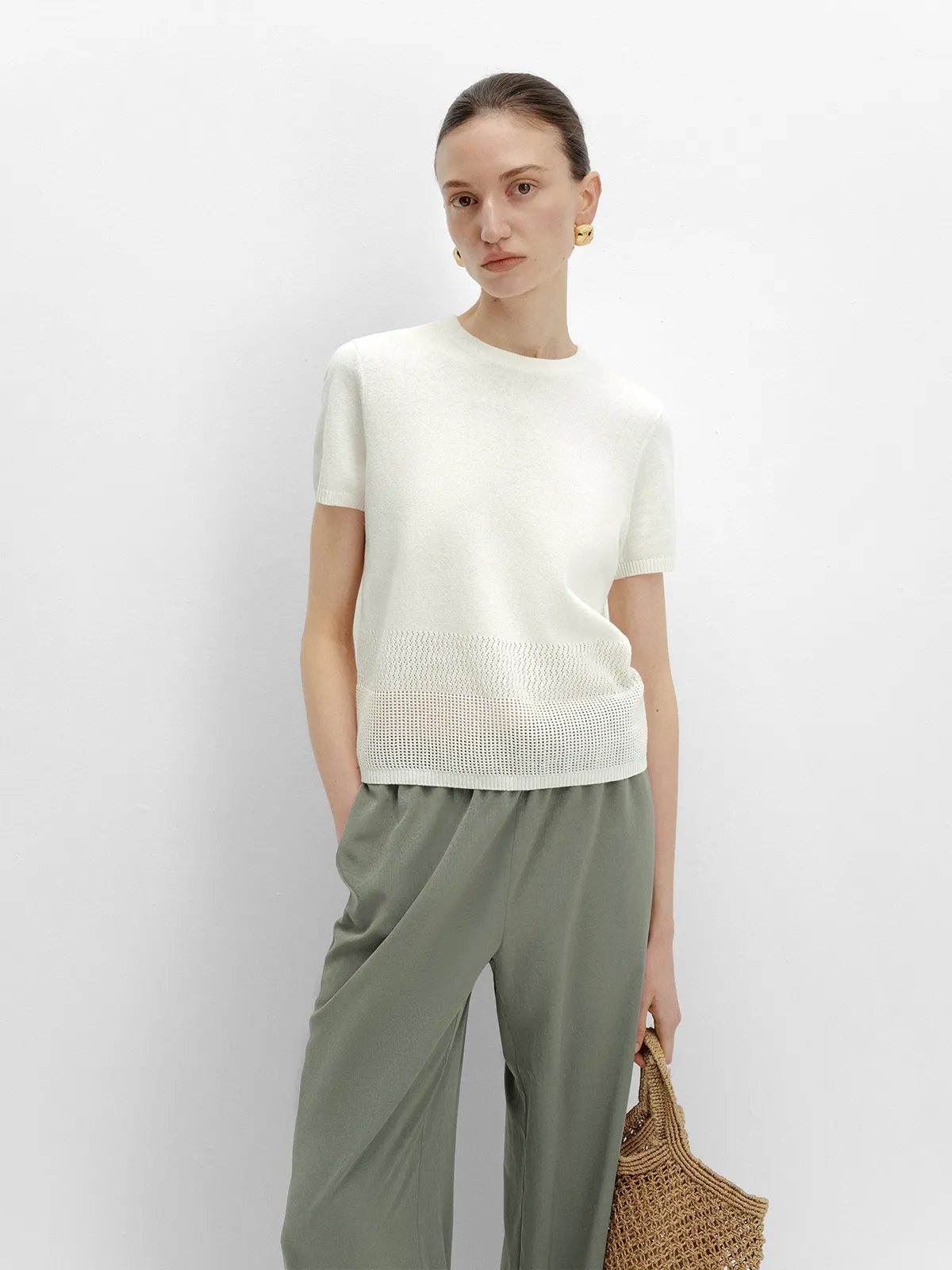 LIANA t-shirt with olive green wide-leg trousers and woven straw tote, studio front view