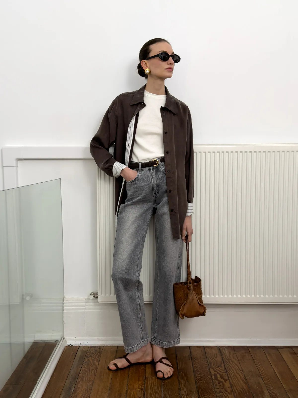 andreatang LUCA fitted t-shirt layered under brown oversized shirt with striped cuffs, paired with grey jeans and leather bucket bag
