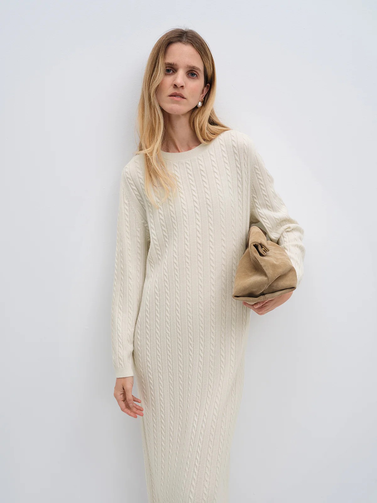 Close-up of andreatang cream Merino wool cable-knit maxi dress showing fine cable texture and crew neckline
