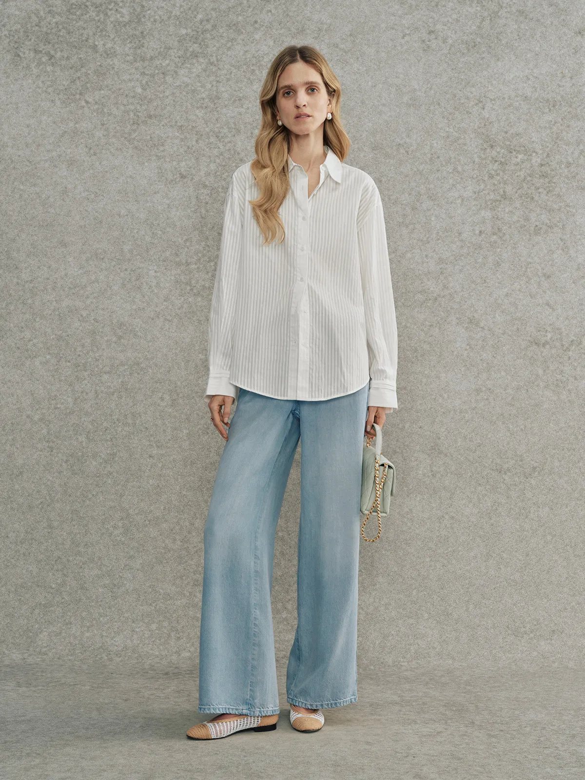 Full-body look: Andrea Tang KIARA striped shirt styled with light-wash wide-leg jeans and woven flats