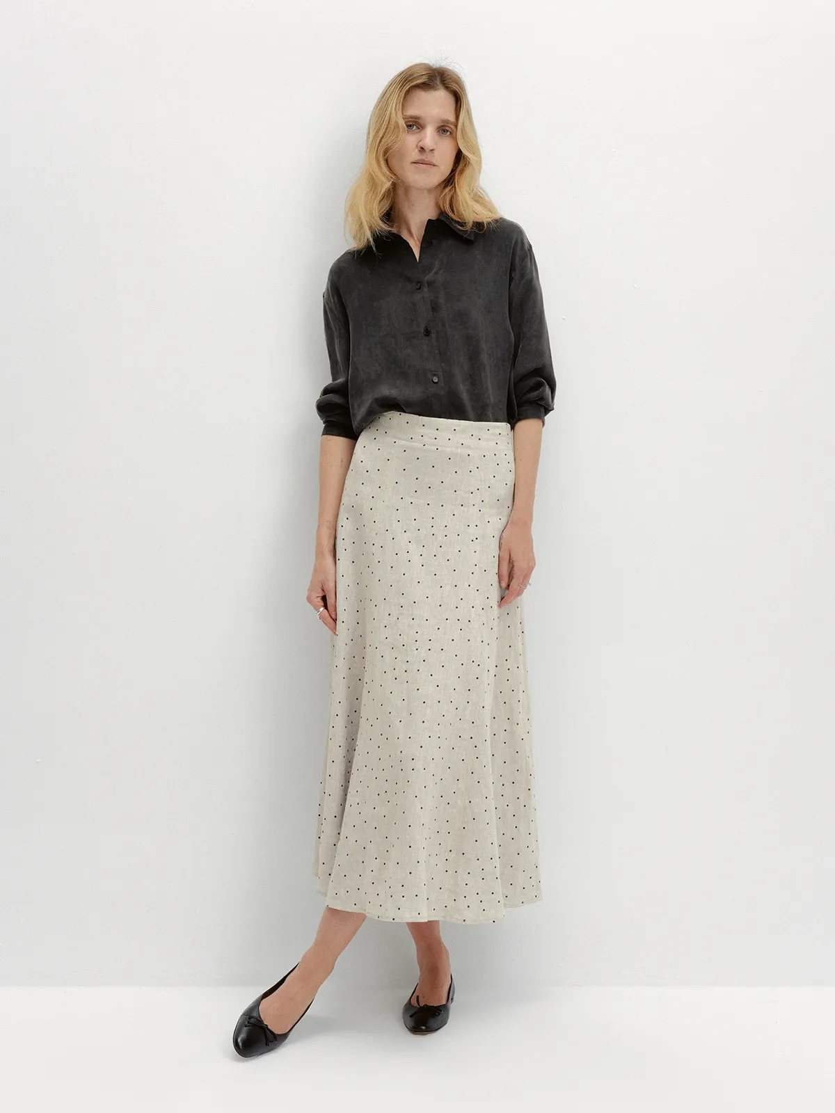 andreatang DOTTIE skirt with charcoal velvet shirt, black ballet flats, full-body front pose