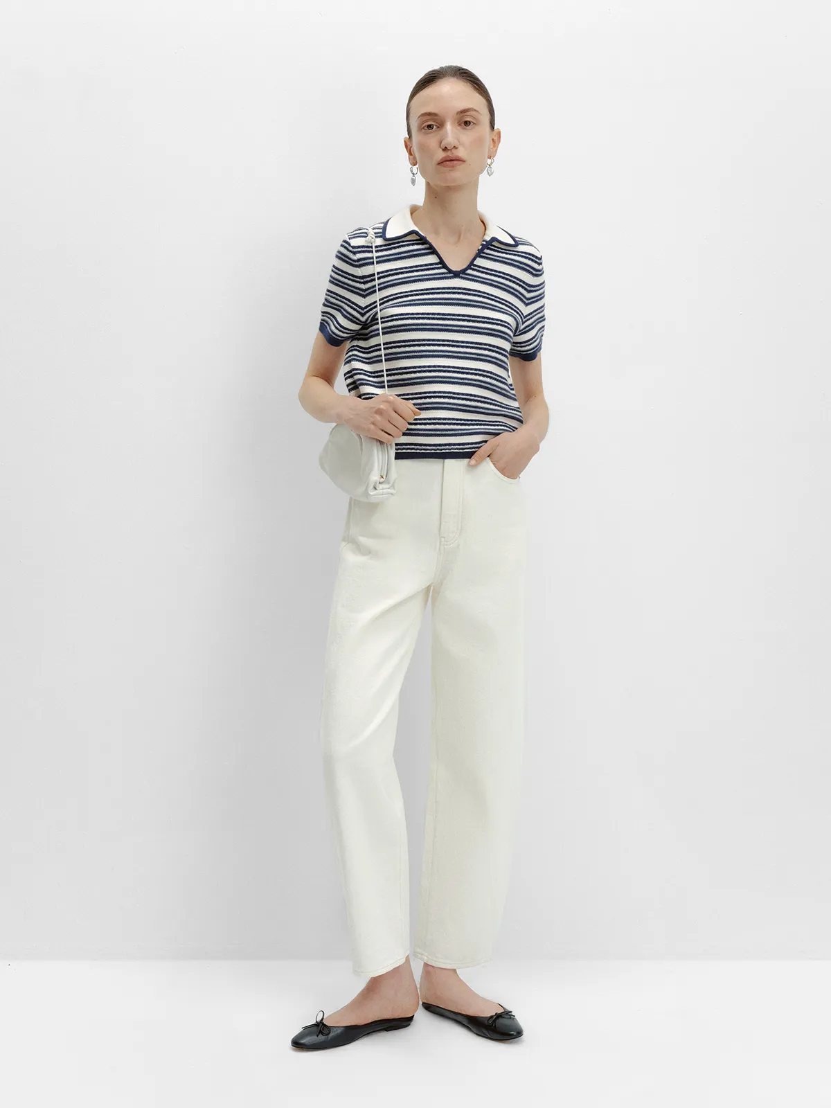 ANGELINA striped knit polo with cream straight-leg jeans, white clutch, and black ballet flats
