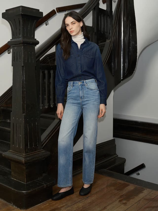 Model wearing JOSETTE slim straight jeans with denim shirt and turtleneck on vintage staircase