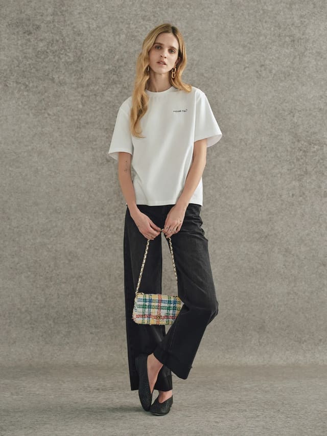 Andreatang white relaxed-fit t-shirt with 'excuse me?' embroidery styled with black wide-leg jeans and plaid tweed bag