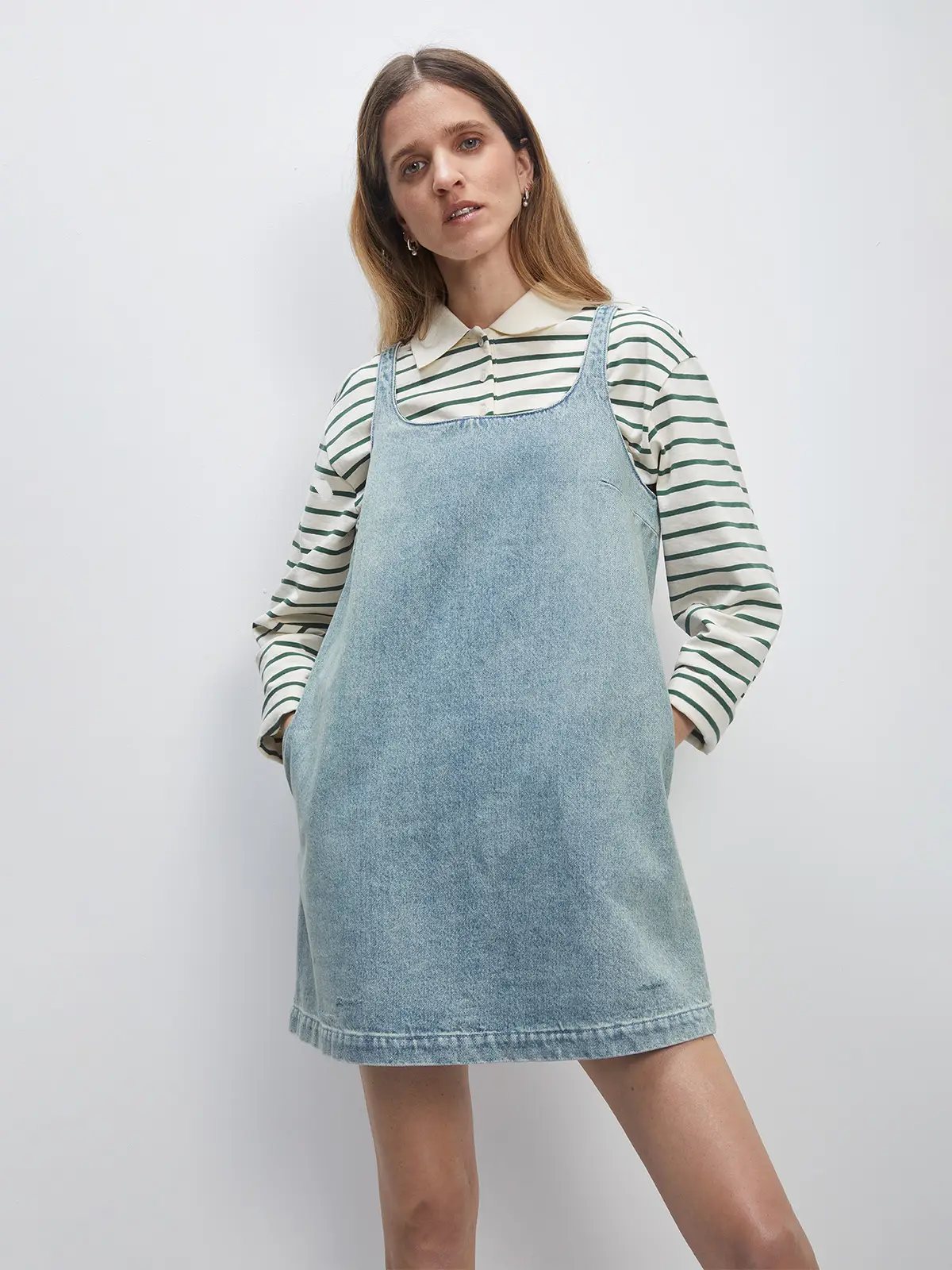 Model wearing a Sky Blue A-line denim dress over a striped collared shirt.