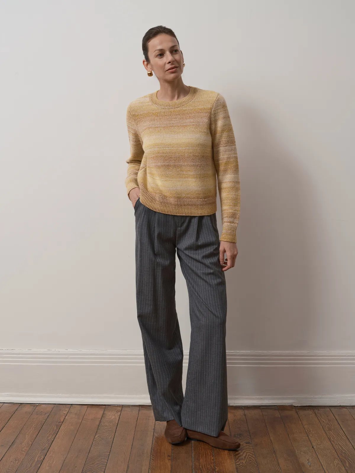 Model wearing TANYA Gradient Stripe Knit Vest with pinstripe wide-leg trousers and tan mules