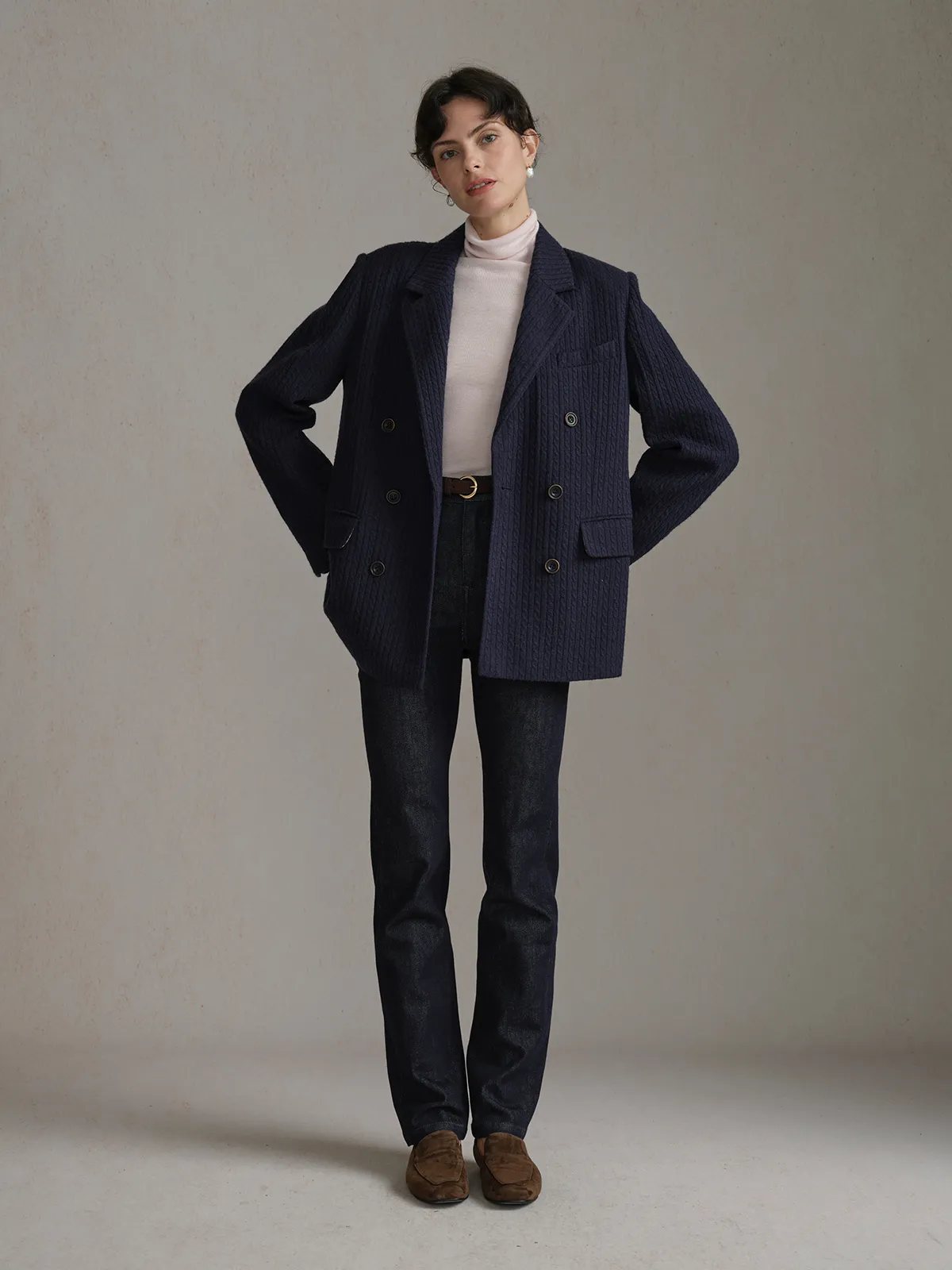 Full-body front view of model in navy HARLOW Cable Knit Blazer, hands on hips, showcasing relaxed silhouette and drape