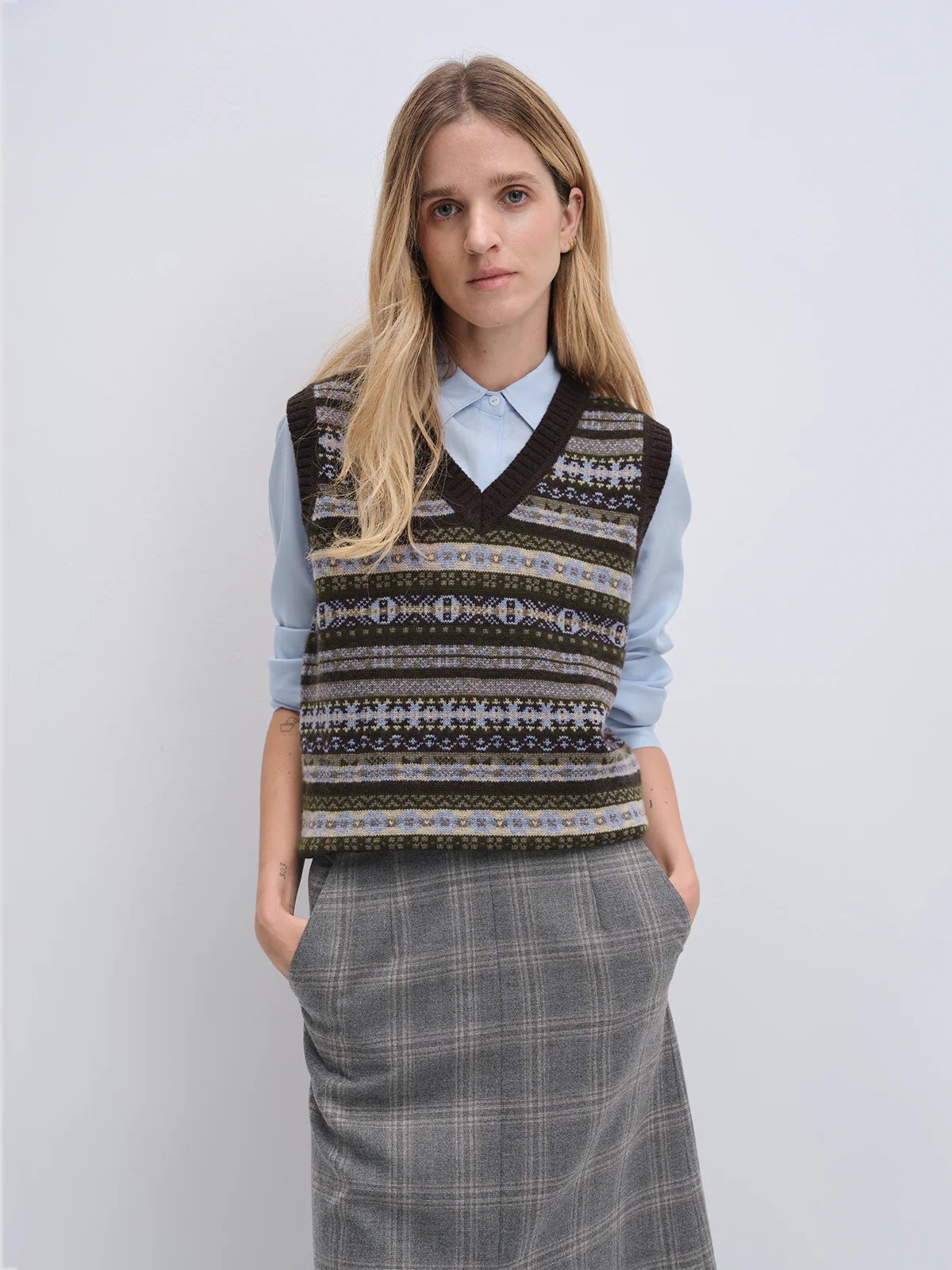 Close-up of the Brown Fair Isle vest’s patterned knit detail over a light collared shirt.