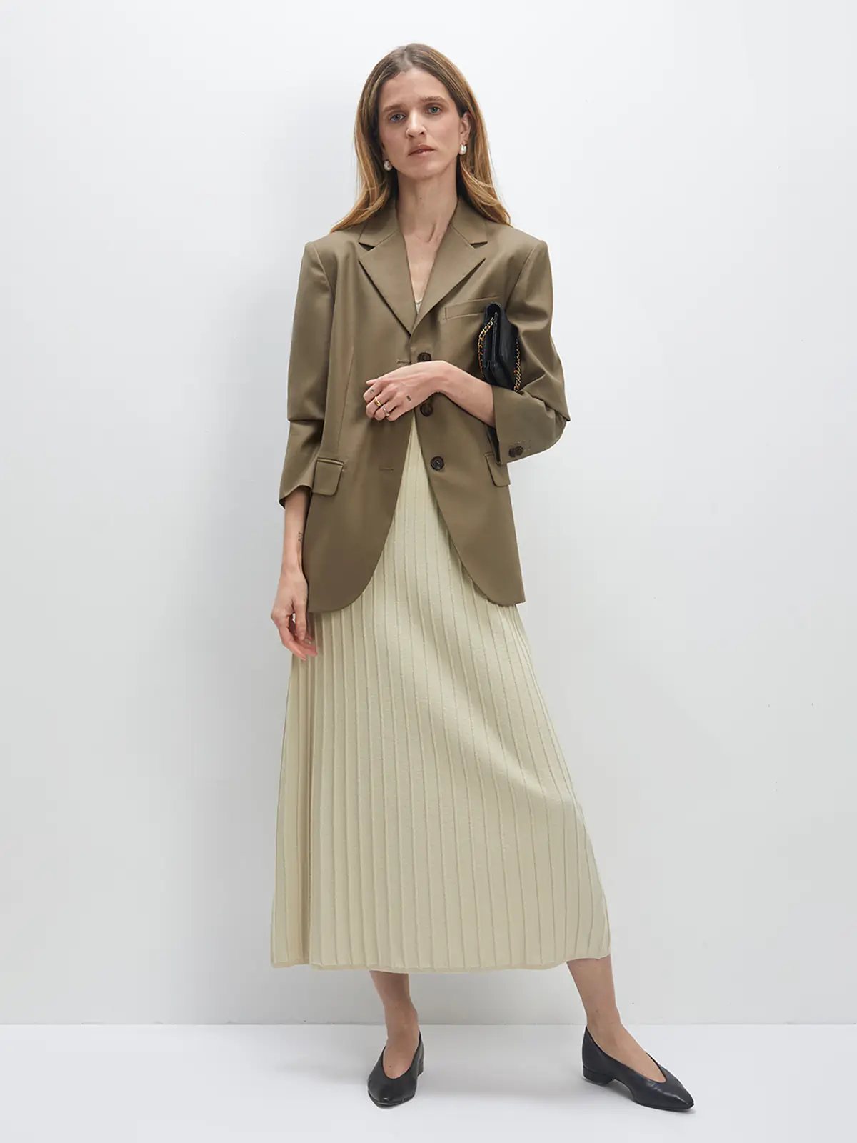 Model wears the Light Lime Green JOCELYN dress layered under a blazer, paired with flats.