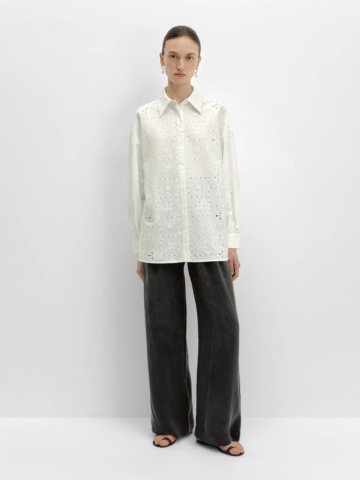 andreatang NOBU Trousers in charcoal grey paired with white eyelet shirt, full-body front view against white studio background