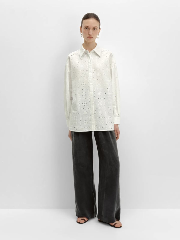 andreatang NOBU Trousers in charcoal grey paired with white eyelet shirt, full-body front view against white studio background