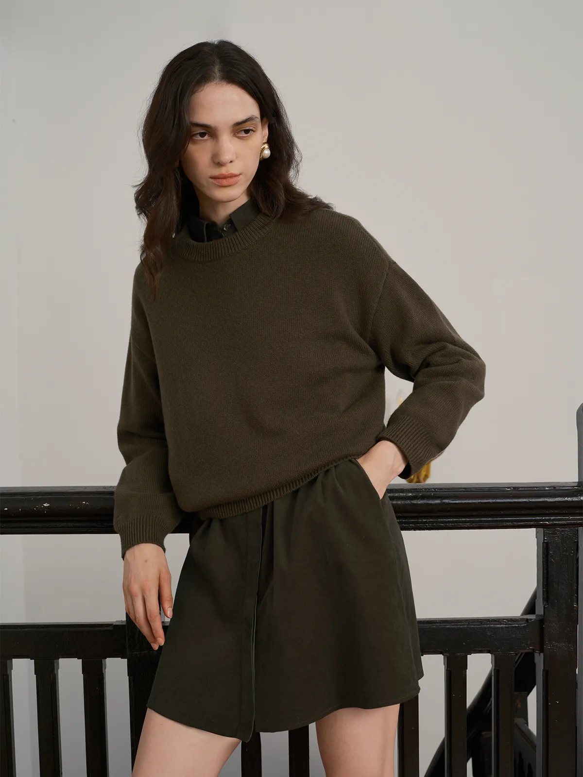 Layered look: JILLIAN dress worn under olive knit sweater with hands in pockets