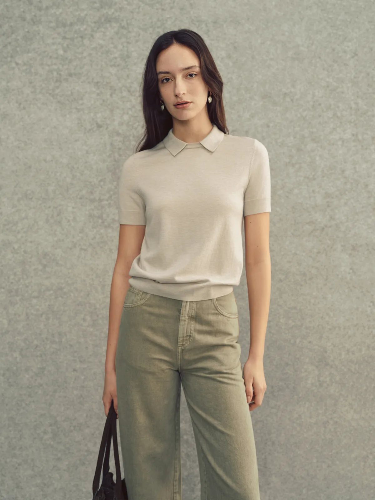 Model in oatmeal AUDREY knit top with olive wide-leg jeans and black tote bag
