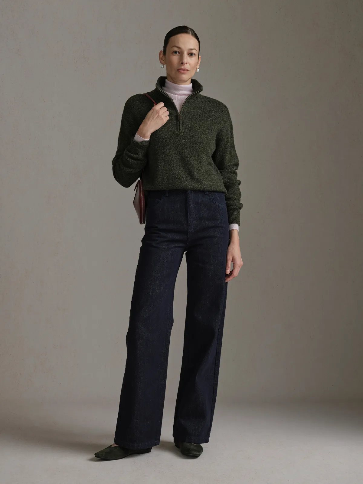 andreatang CLOVER pink detail jeans full-body front view with olive green half-zip sweater and pearl earrings