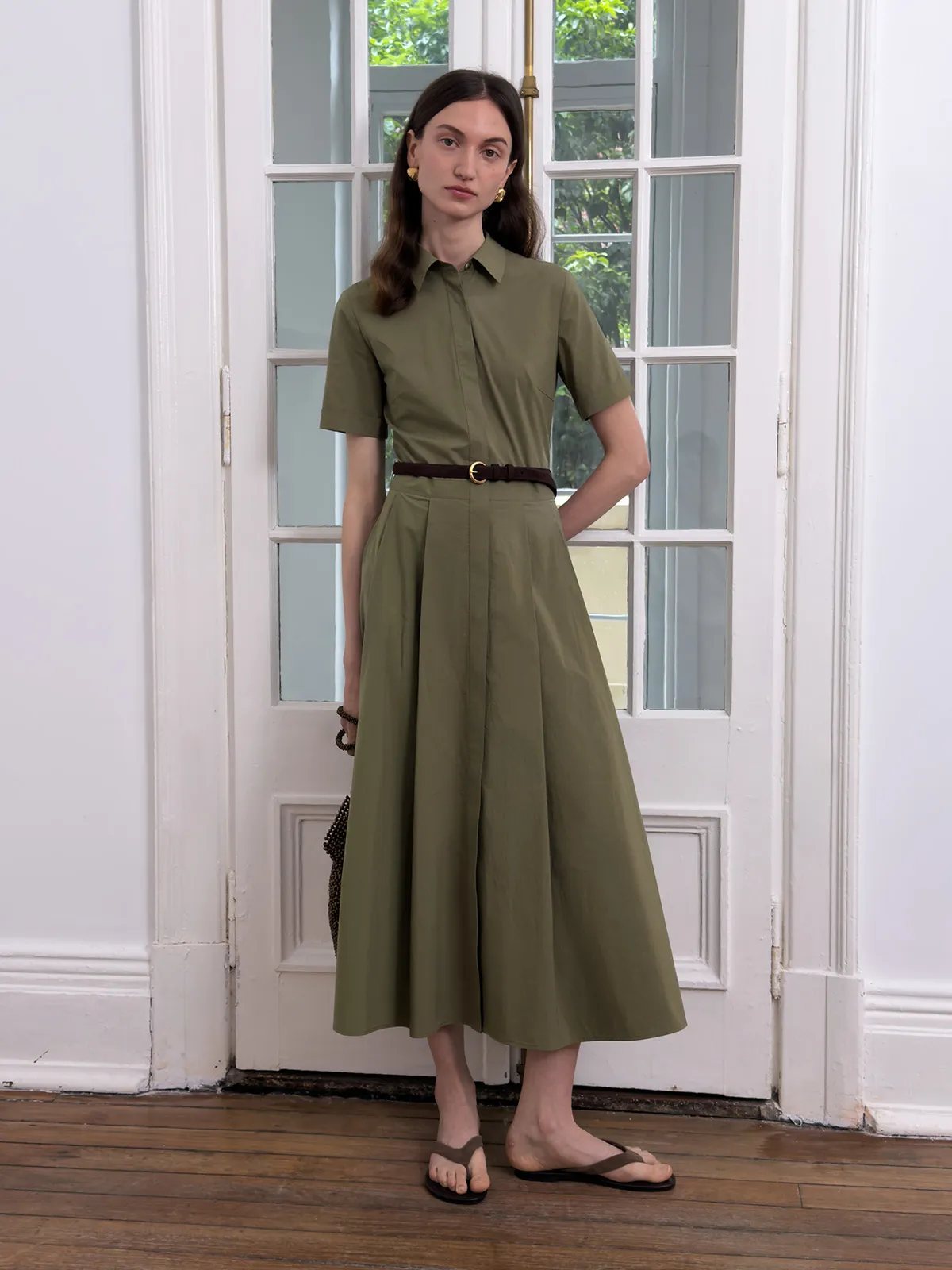 IMANI dress styled with thin brown leather belt and gold hardware, model by French doors