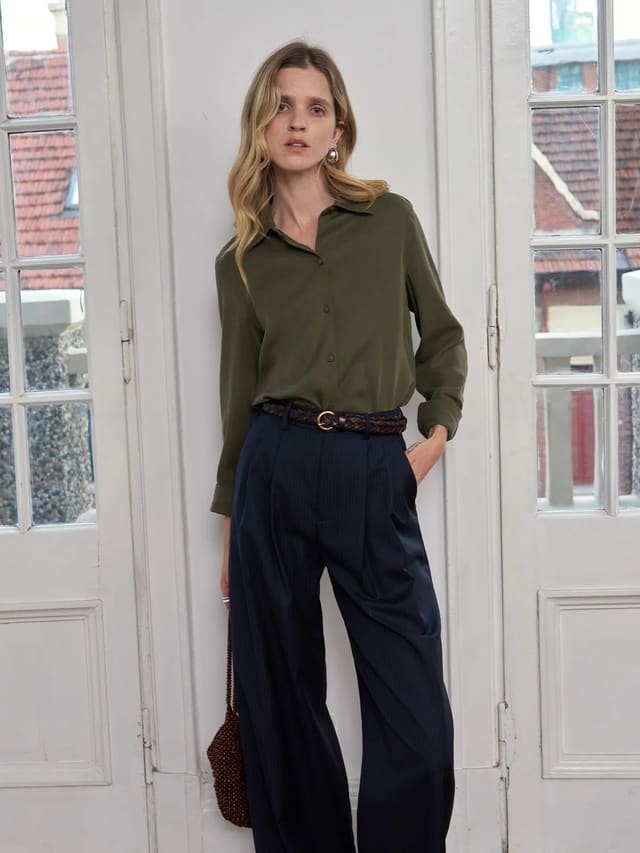 Andreatang ERIN Classic Lyocell Shirt in olive green styled with navy pleated trousers and woven leather belt — quiet luxury minimalist outfit