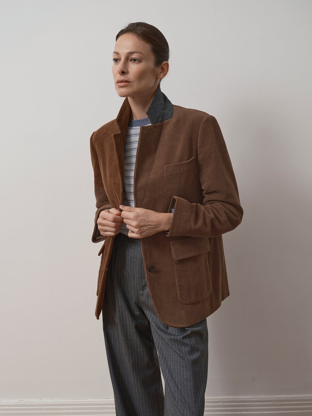 Model adjusting KIMBERLEY corduroy blazer showing contrast collar lining and relaxed fit