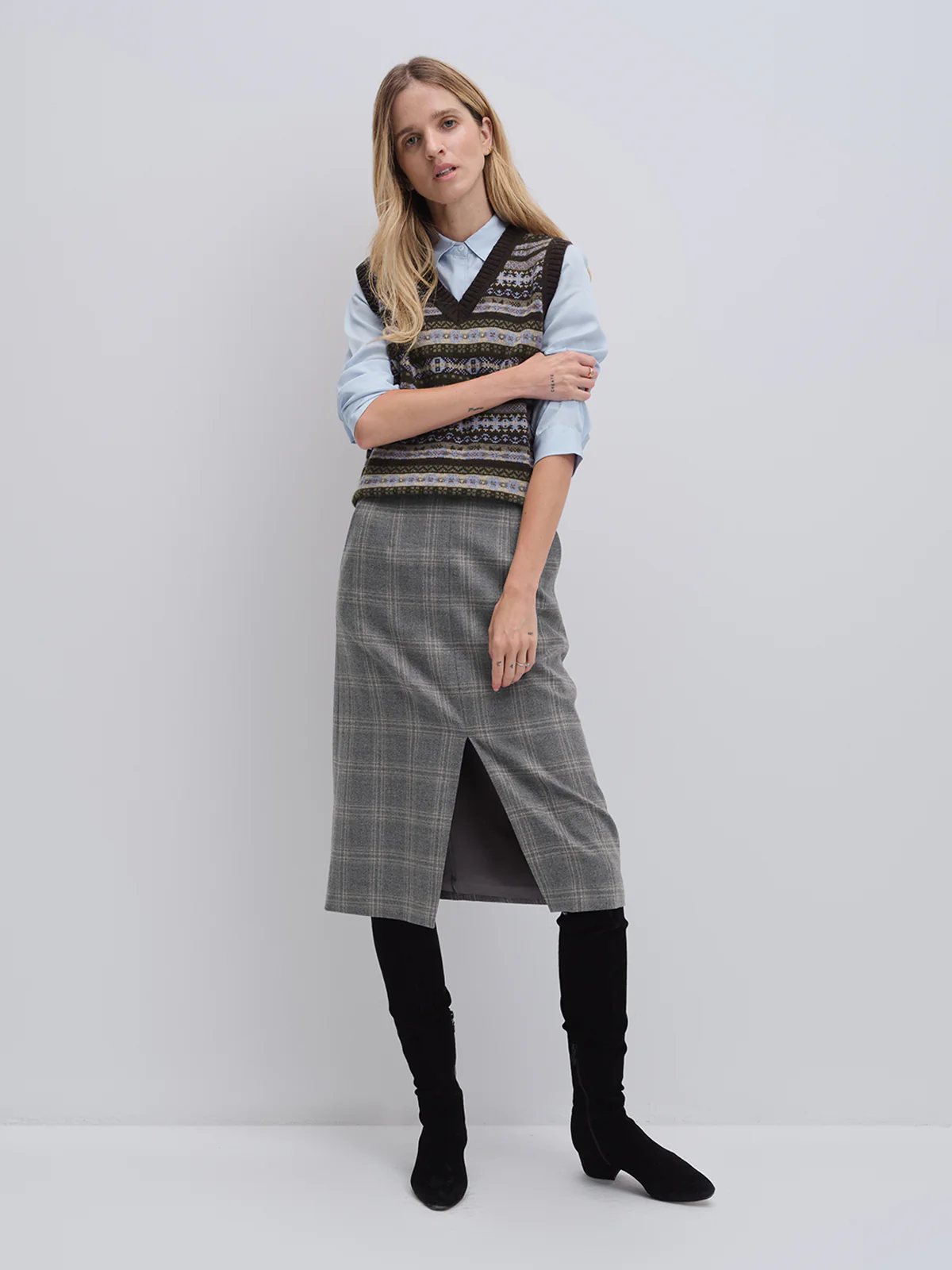 andreatang wool check midi skirt styled with blue shirt and Fair Isle knit vest, knee-high boots
