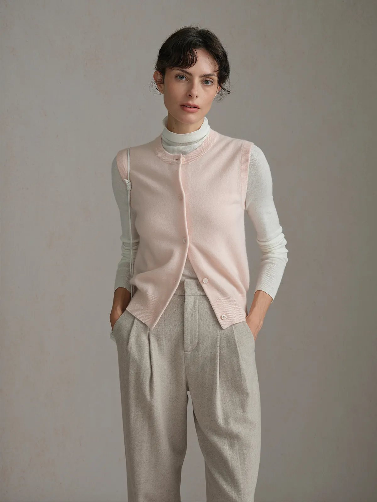 Front three-quarter view of RANDY vest layered over turtleneck, hands in pockets