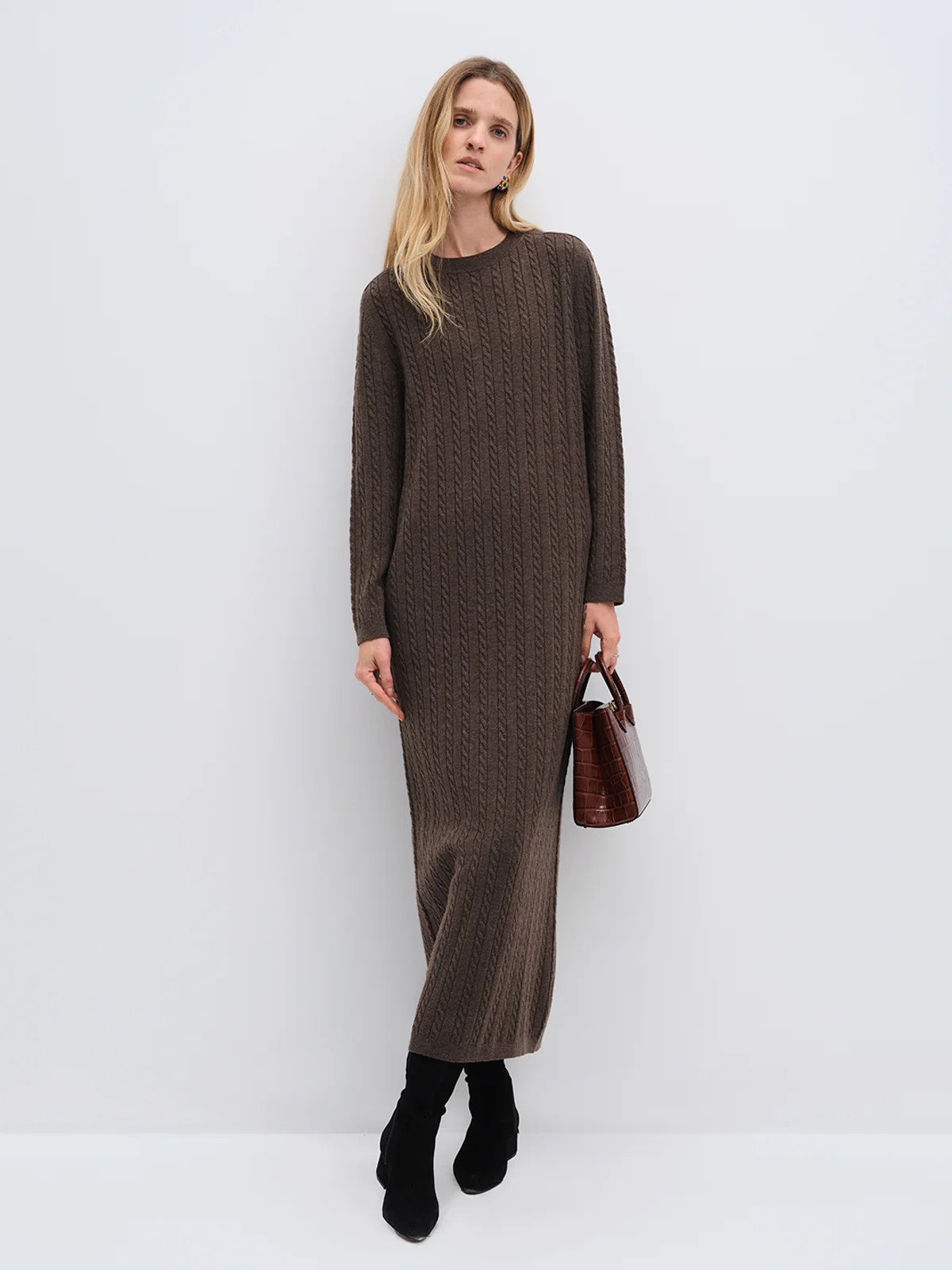 Model wearing andreatang cream Merino cable-knit maxi dress over a charcoal turtleneck with black boots