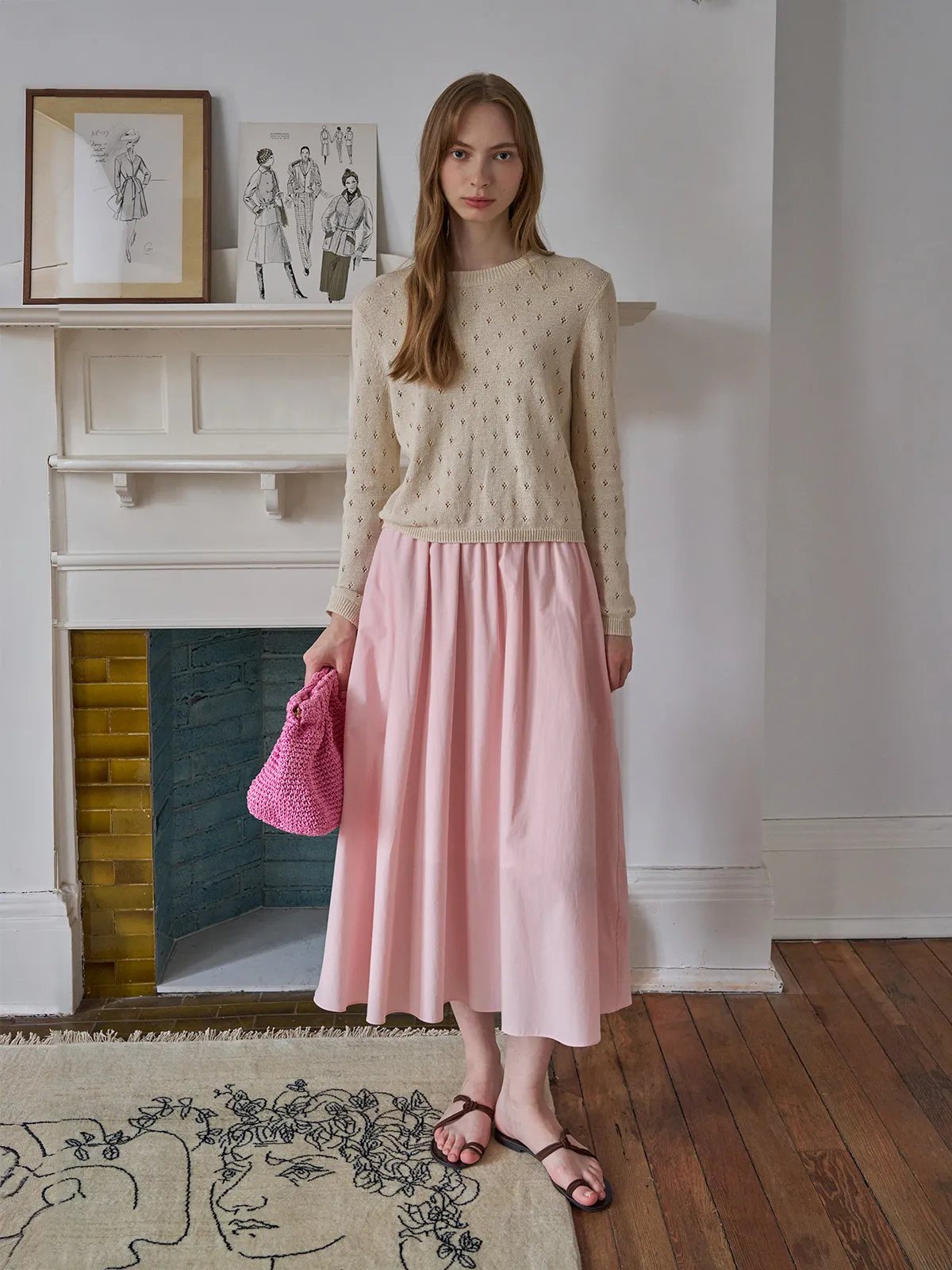 Model wearing KIANA top with blush pink midi skirt and handwoven pink crochet bag