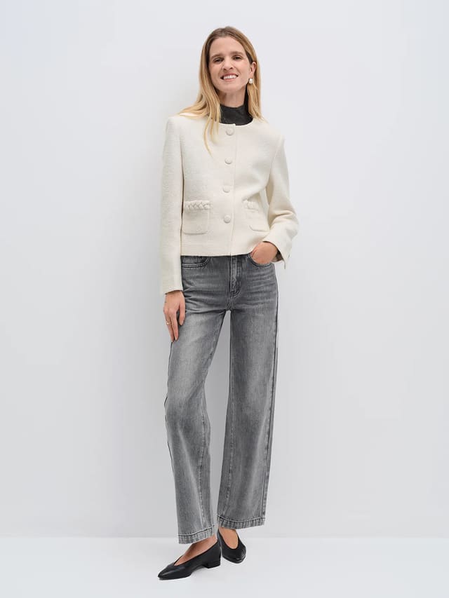 Model wearing andreatang ivory wool-blend tweed cropped jacket with covered buttons, grey jeans and black flats