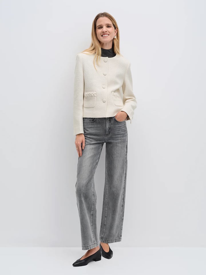Model wearing andreatang ivory wool-blend tweed cropped jacket with covered buttons, grey jeans and black flats