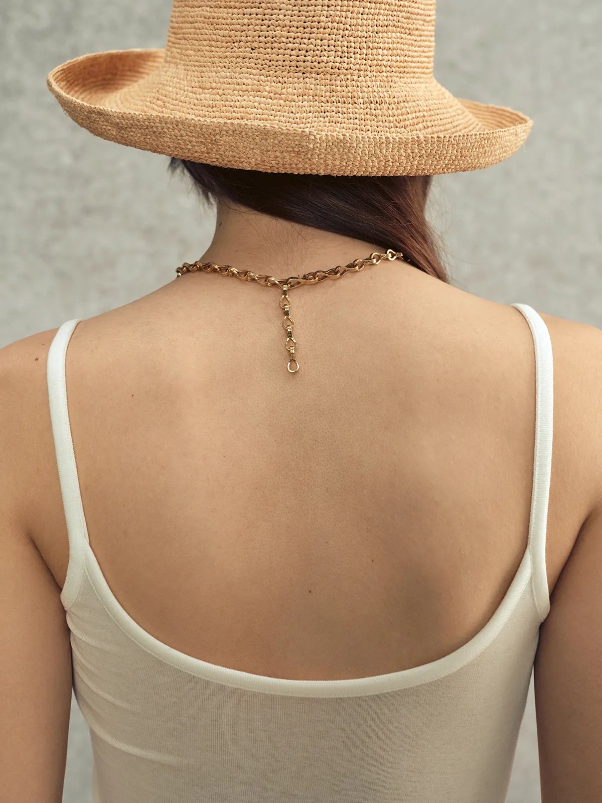Back view of ivory LANA camisole showing low scoop back and gold chain strap detail — elegant minimalism