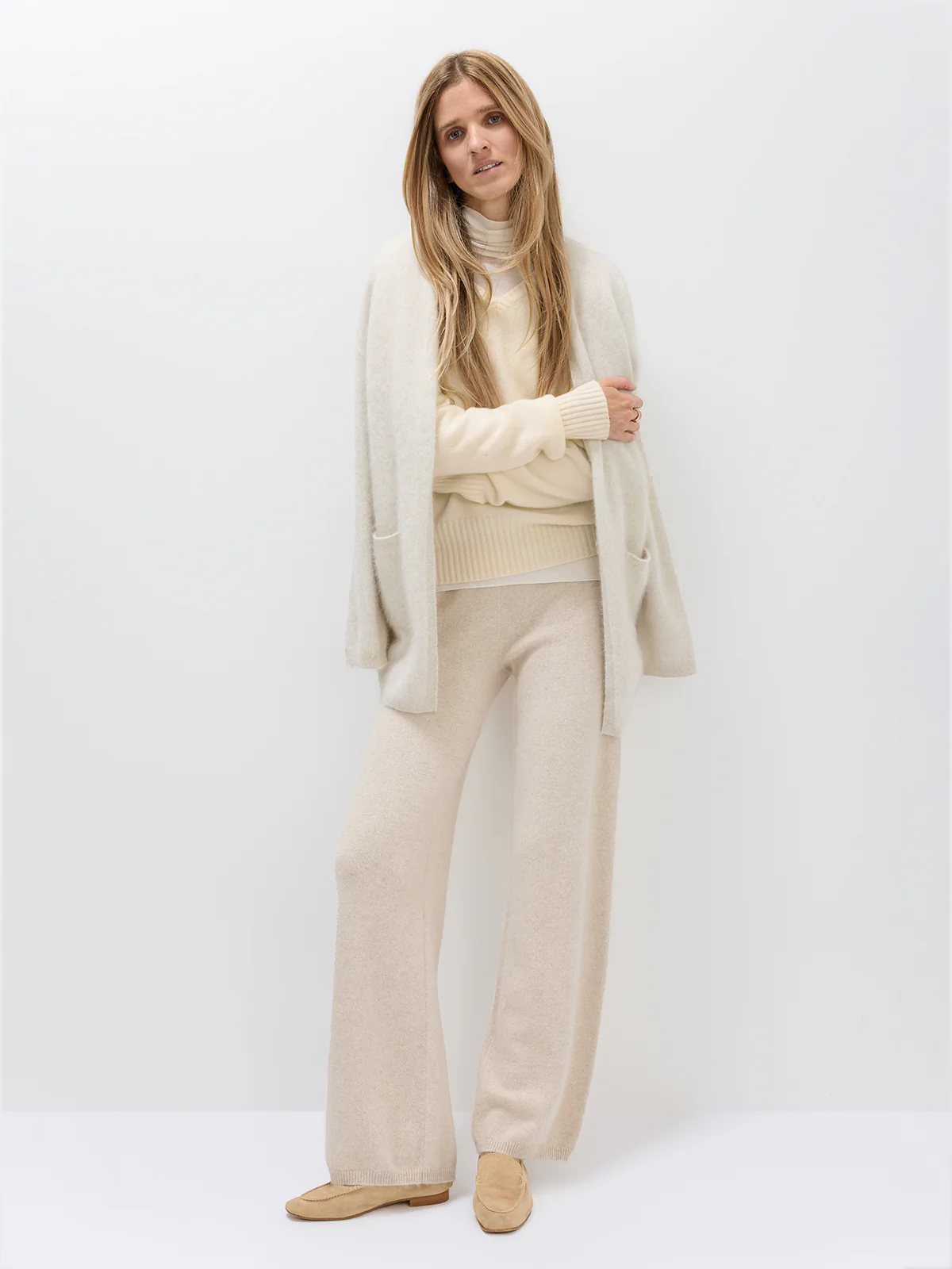 Close-up side view of model wearing the Oatmeal cardigan, highlighting its soft knit texture and relaxed fit.