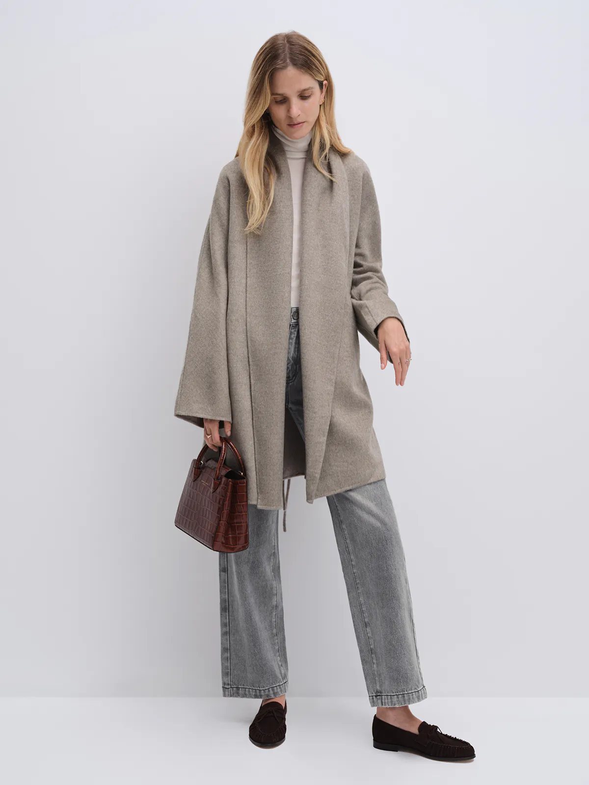 Front view of a model wearing the Taupe yak wool robe coat open, revealing a turtleneck underneath and wide sleeve silhouette.