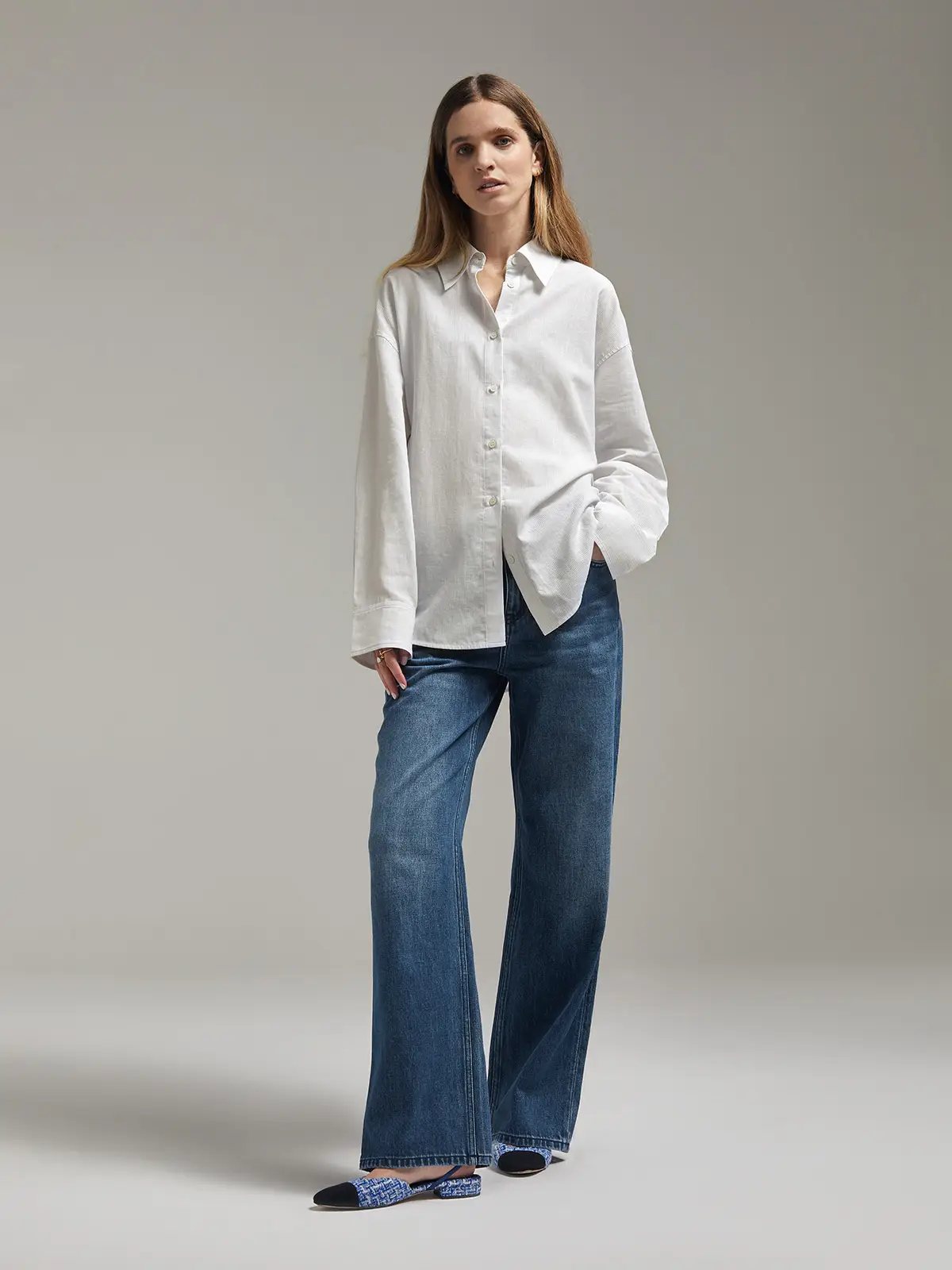 Back view showing Blue retro dark blue waist straight jeans with visible back pockets and a top.