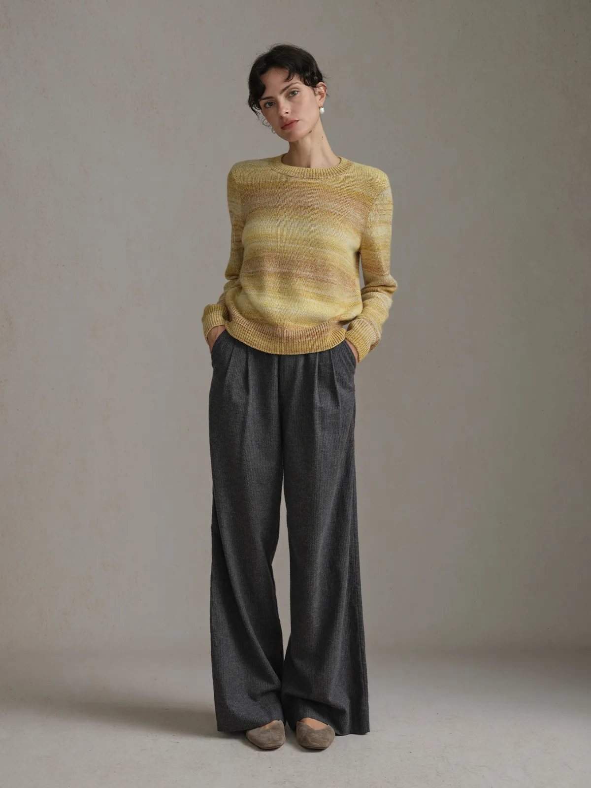 Model wearing TANYA Gradient Stripe Knit Vest with charcoal wide-leg trousers and suede loafers in studio setting
