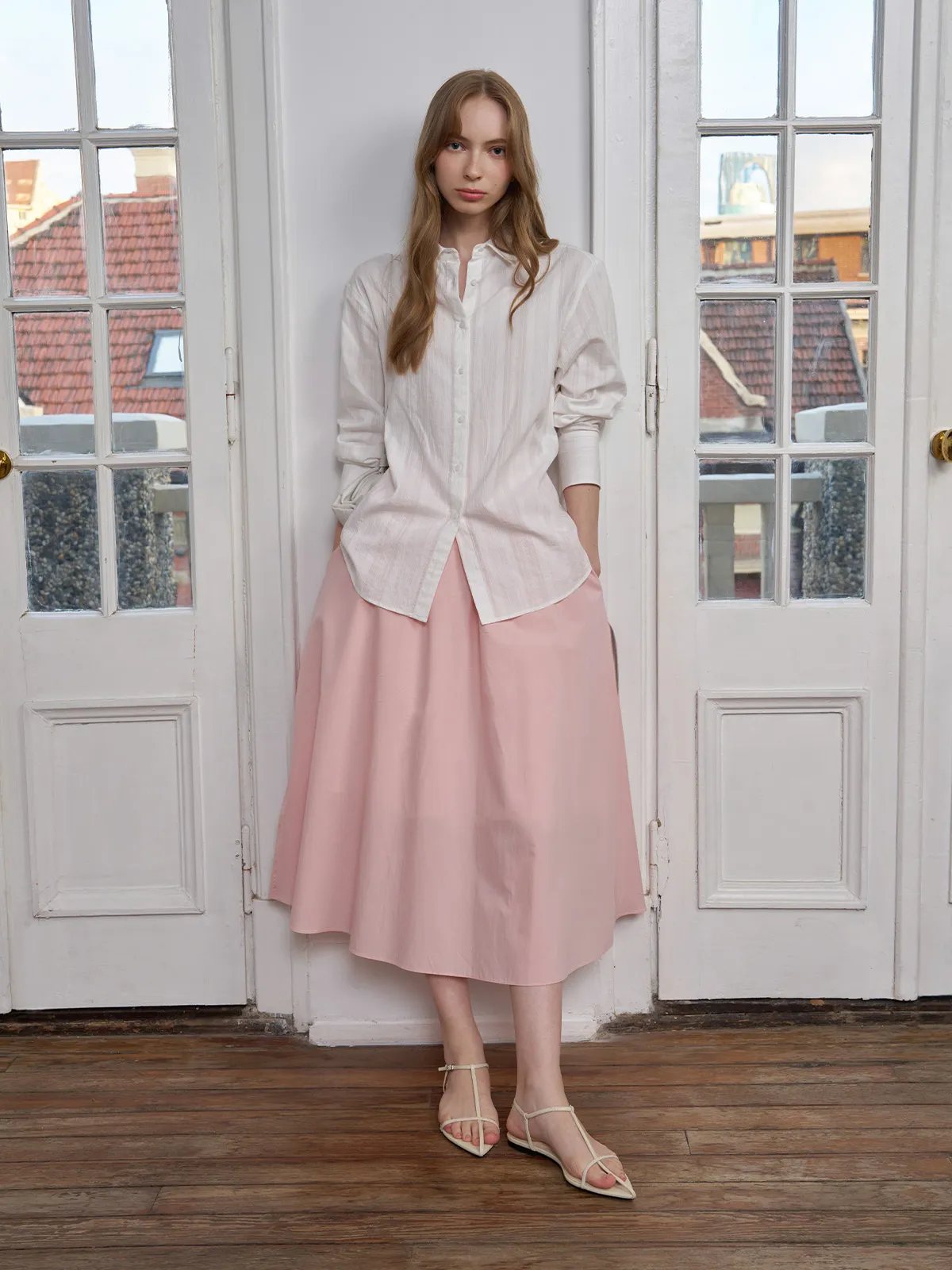 Model wearing RORY cotton jacquard shirt with blush pink midi skirt in vintage room