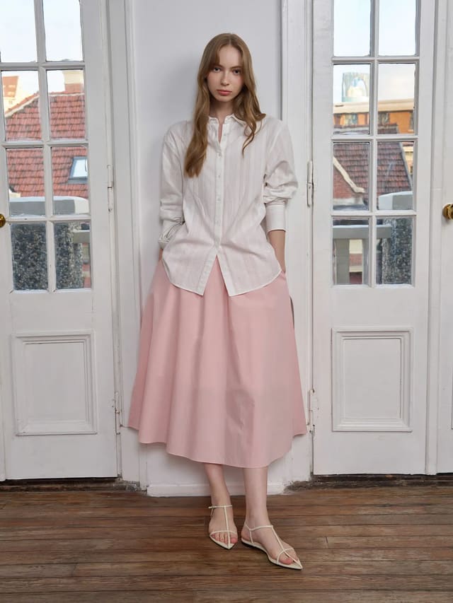 Model wearing RORY cotton jacquard shirt with blush pink midi skirt in vintage room