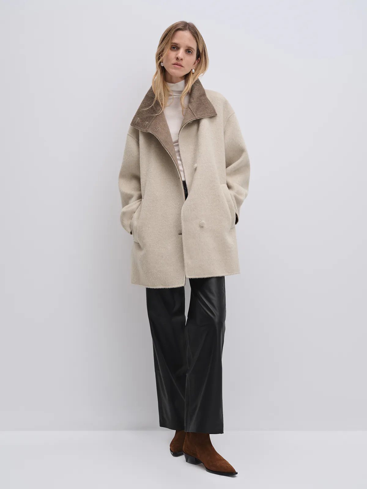 Close-up side view of the Oatmeal coat’s high collar and shoulder seam, showing texture and construction.